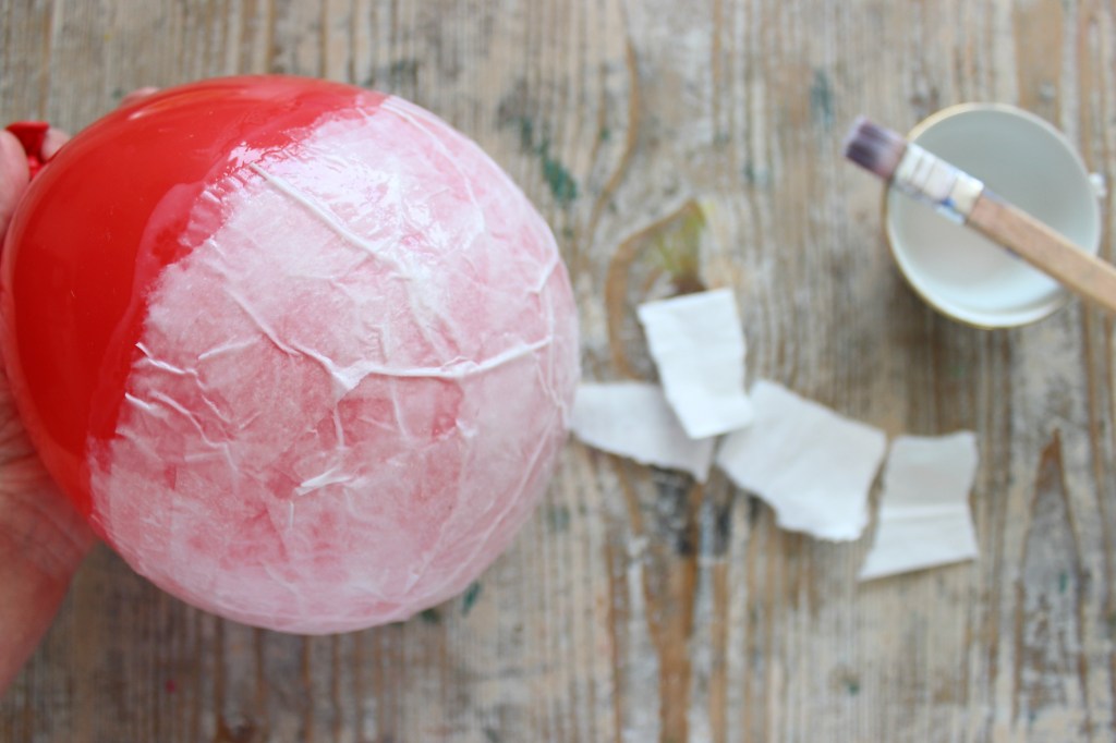 rivestire un palloncino di carta con la carta velina per creare una lanterna